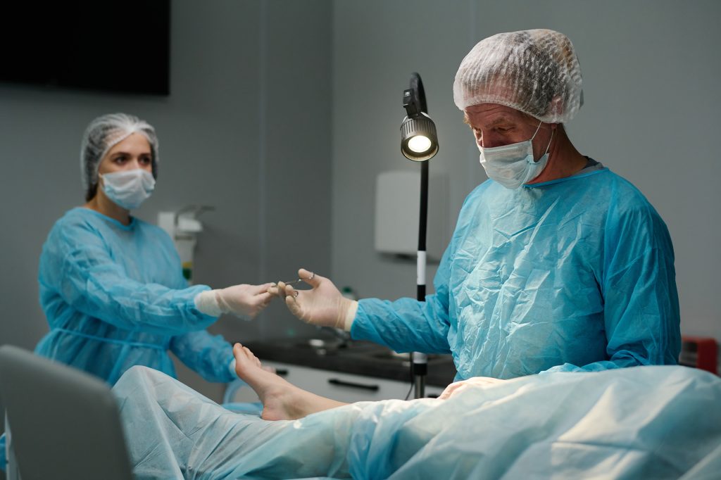 A surgeon performing surgery on a patient’s foot