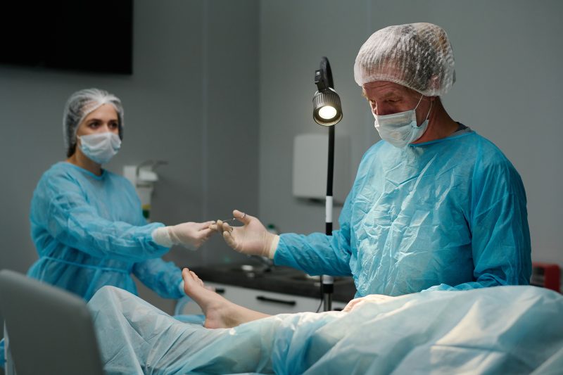 A surgeon performing surgery on a patient’s foot
