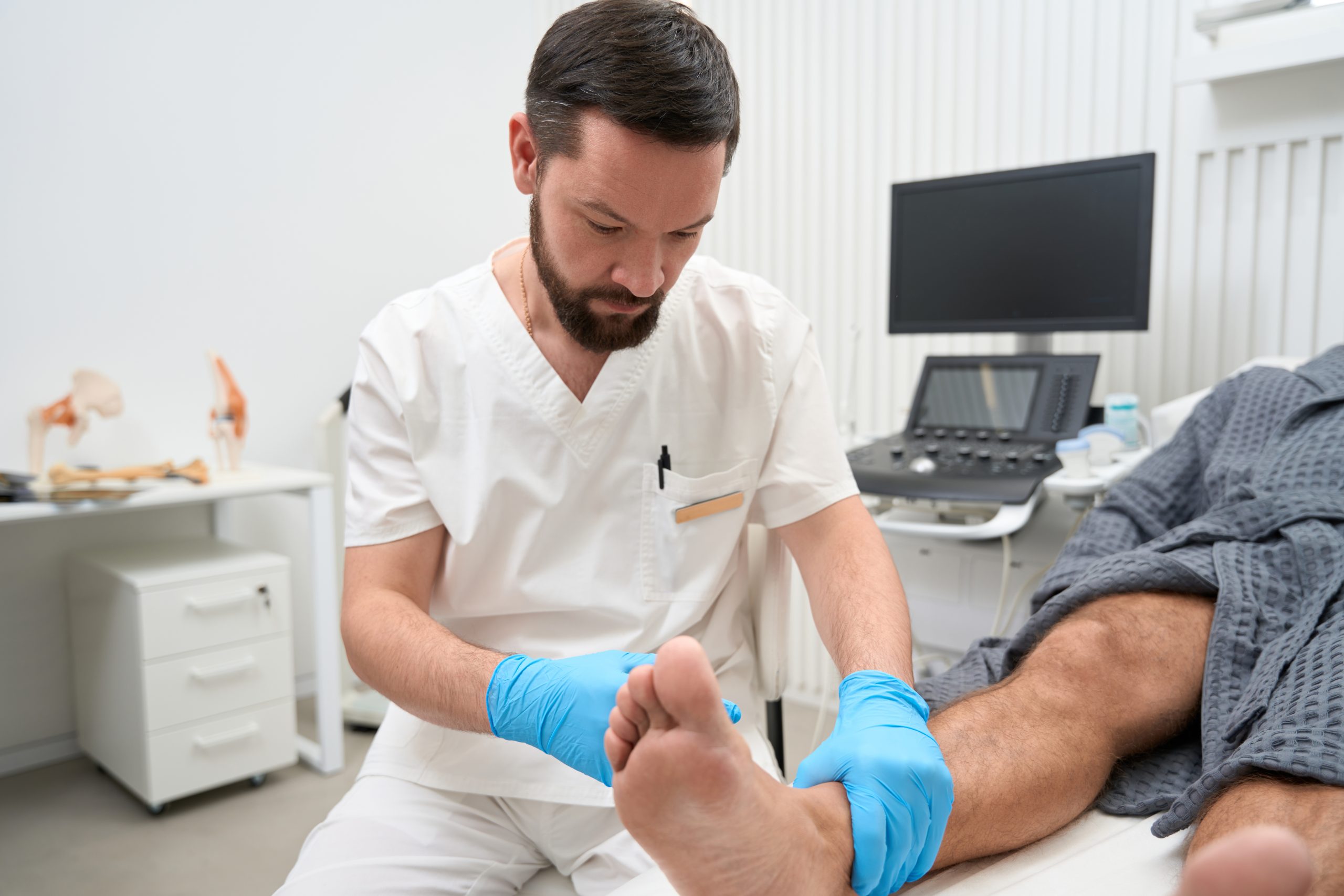 Podiatrist examining patient for risk factors for bunions